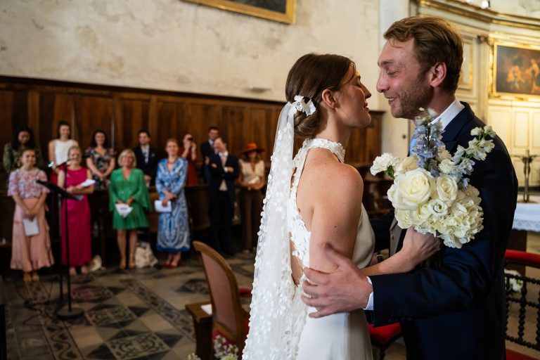 Couple de mariés dans l'église se regardant.
